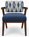 A modern accent chair with a dark brown wooden frame, a solid blue upholstered seat cushion, and a patterned blue and cream ikat backrest, shown against a plain white background.