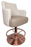 A modern swivel barstool with a light beige upholstered seat and curved backrest, supported by a polished copper-colored metal swivel base with a circular footrest.