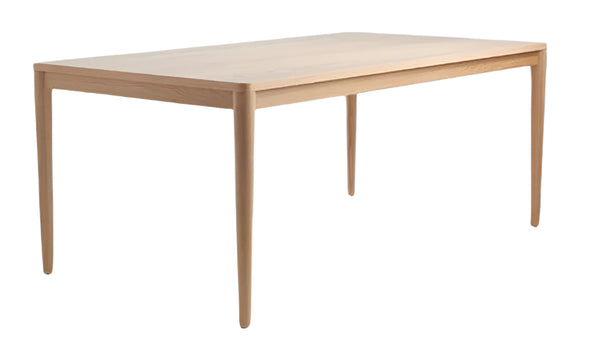 A rectangular Clare Timber Table with a natural wood finish and simple, clean lines.